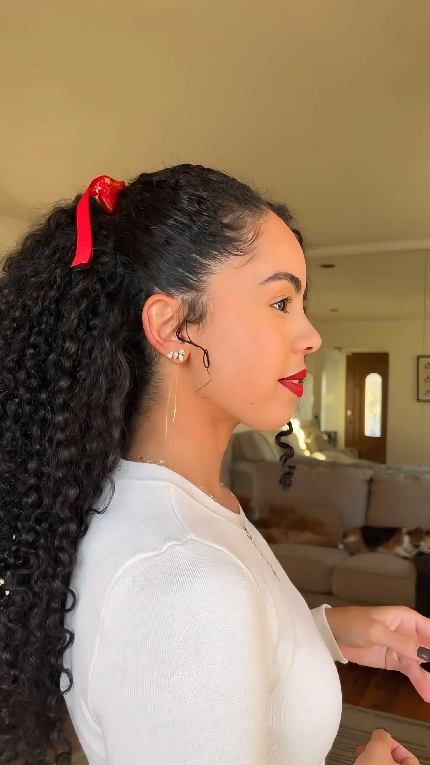 Curly Hair Ponytail With a Red Ribbon